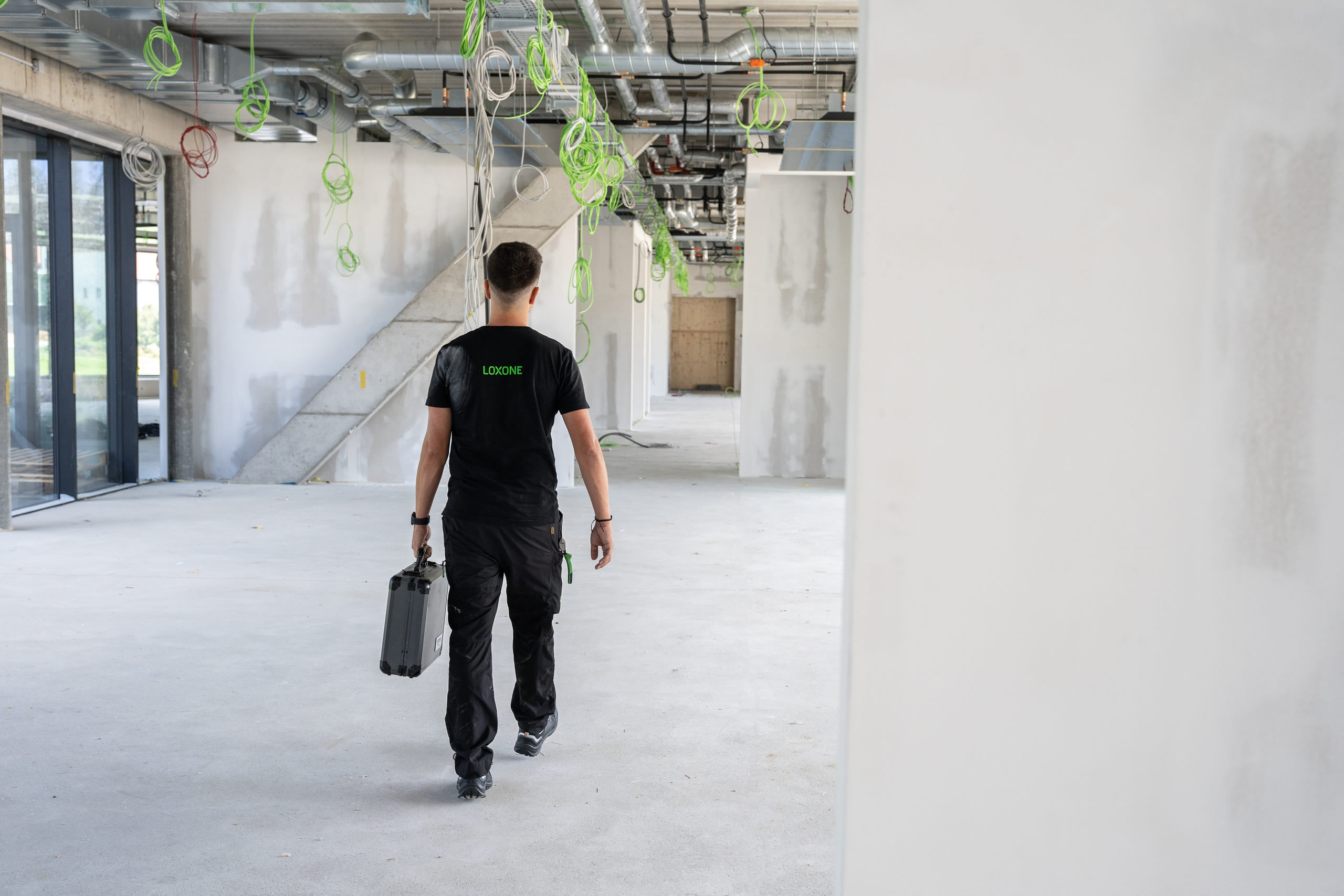 Loxone installer coordinating automation during a construction-stage build